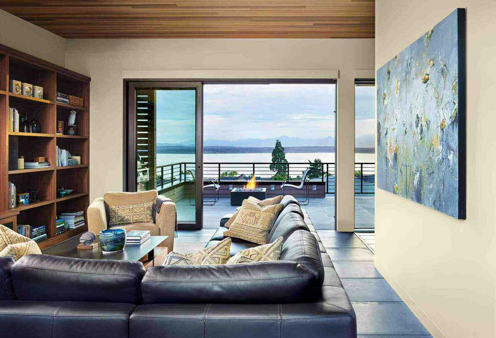 Overlooking the living room sofa from Designer Furniture Galleries is a painting by Michael Schultheis.