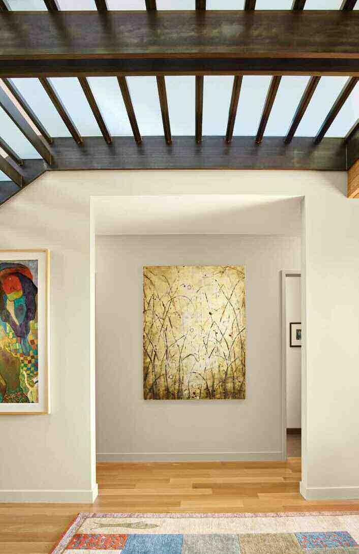 Right: The team conceived the house with the owners art collection in mind, so even the hallway to the bedrooms serves as a display space for works, including a
