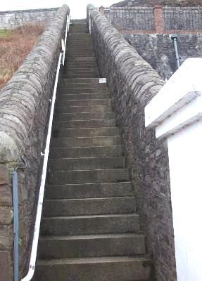 There is handrail to the right as descending the steps. There are two flat areas to rest on the descent/ascent.