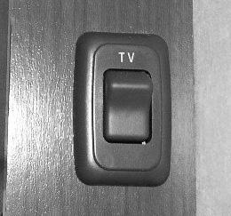 Front TV Ignition Switch Interlock -Typical View DVD HOME THEATER SYSTEM If Equipped BEDROOM TV 12-VOLT MASTER POWER SWITCH If Equipped The Bedroom TV 12-Volt Master Power switch is powered by