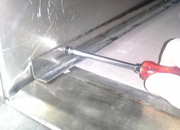 Place a screw driver or other tool into the hole in the front of the forward deck clamp.