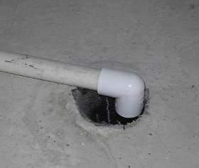 (more commonly known as a "floor drain"). This drain is designed to drain off water should the water heater or washing machine overflow, for example.