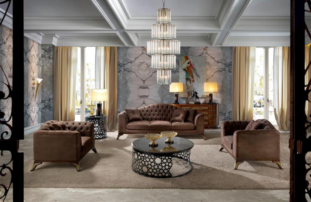 Inspired by mid-century style, the linear design of the 4553 sofa is softened by the refined buttoning of the back and the golden accents that reinforce its sophisticated allure.