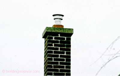 Photograph 8: New Chimney Liner notice the new smaller sheet metal flue installed inside the larger original masonry chimney that served the