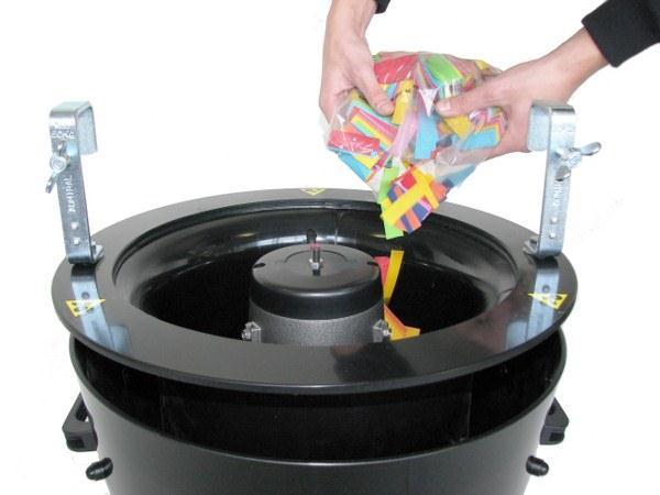 Remove the grid by turning the fastener in the left direction and lifting the grid up by hand. 2. Fill the reservoir of the Swirl Fan with confetti.