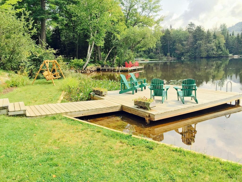 6 of 9 8/26/2016 4:45 PM Porch, Decking, Docks, Hot Tub, Lean-To, Firepit, Yard, & Parking: Wrap-around porch w/5 rockers Large front and rear yard with play area 2 docks great for fishing/swimming