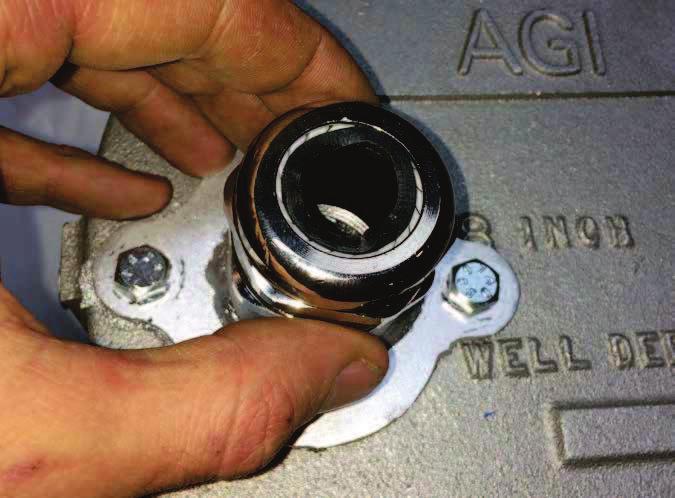 7 Locate the bracket on the well cap or seal and mark a drill-hole location by inserting a marker through the threaded center hole of the bracket.