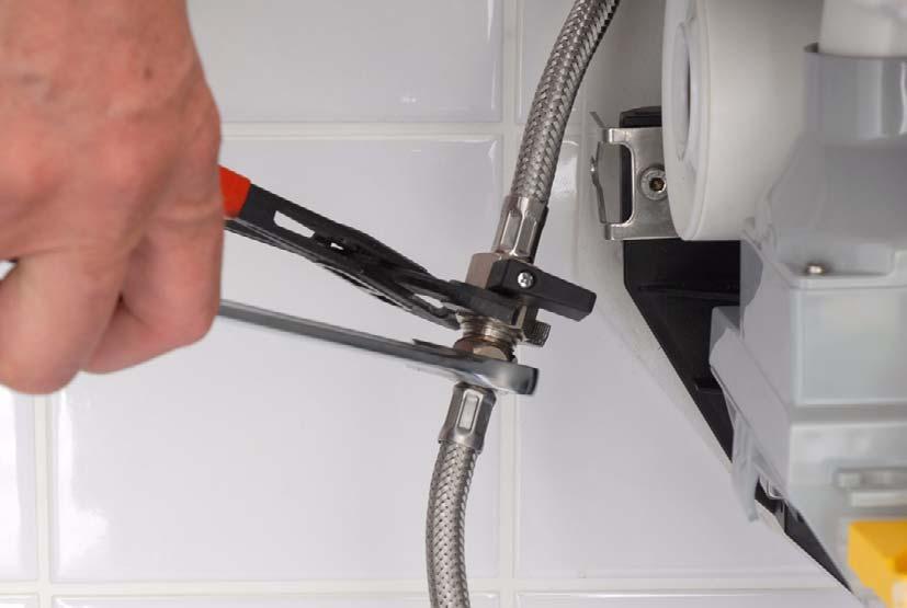 19 Press the storage water heater towards the rear wall and release it from the
