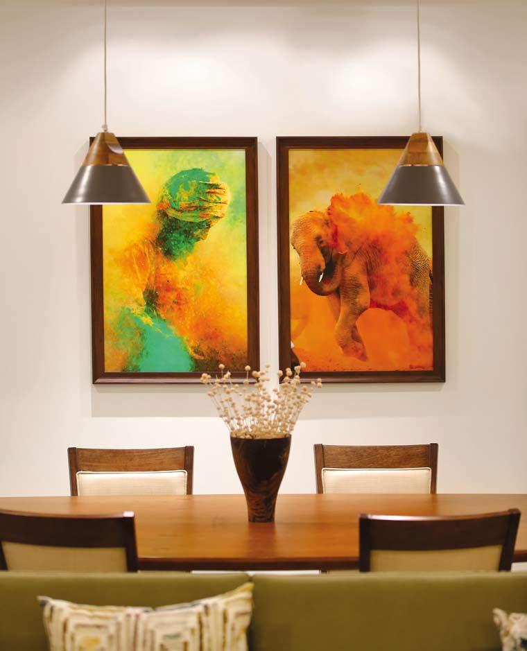 Integrated with the living area, the dining space shows off contemporary hanging lights in subtle