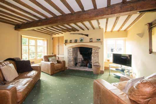 A traditional period farmhouse with a separate barn conversion and