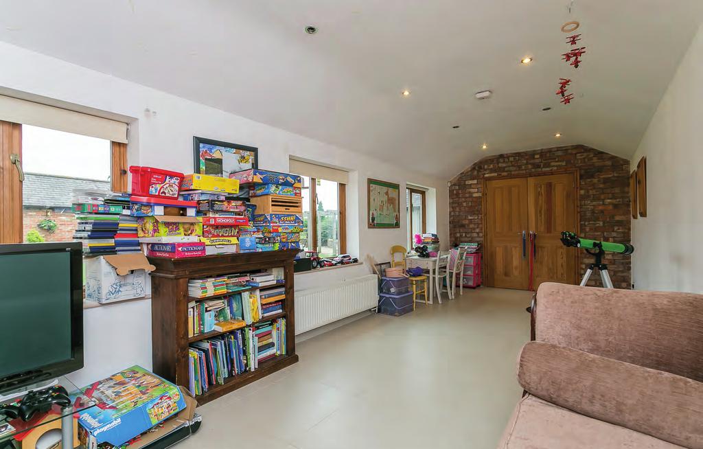 Currently used as a play room / hobby room this room is extremely spacious and could be used for many purposes and leads to an office. Both rooms overlook the courtyard.