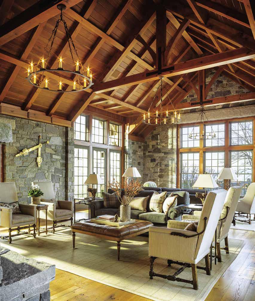 Local Vermont granite gives considerable heft to the great room, where a double-sided fireplace rises to a soaring peak in the living room.