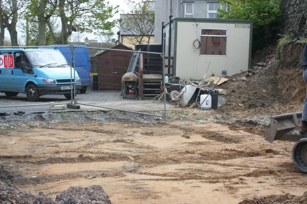 Plate 11: Tarmac driveway area on removal of tarmac and hardcore layer (C102), showing natural sand subsoil, looking south west.