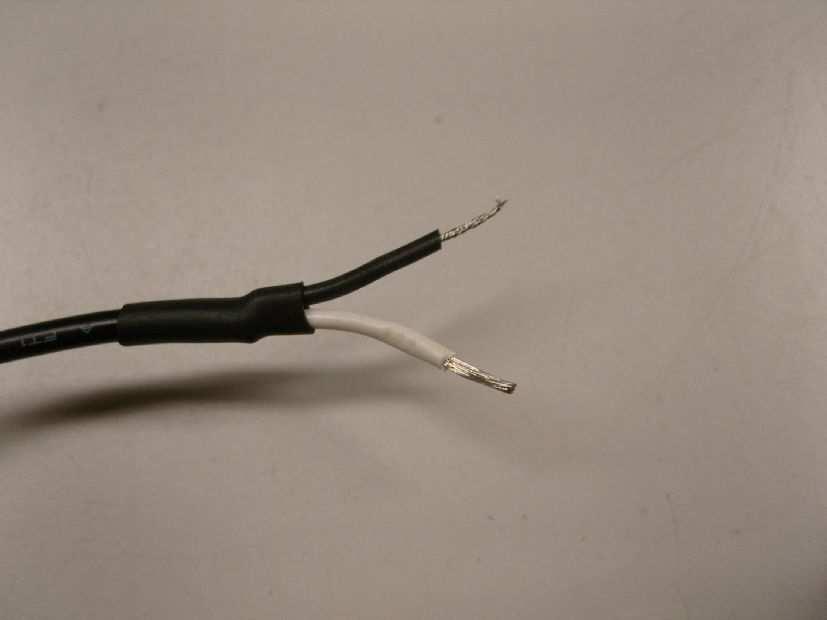 Twist the red wire with the white wire and then the two black wires together as shown and crimp with red and black 1.