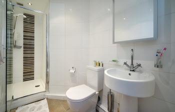 ENSUITE SHOWER ROOM: Double shower cubicle with Mira shower unit, pedestal wash