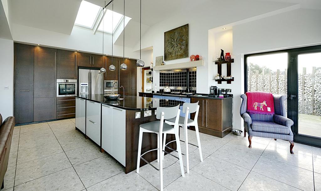 KITCHEN: Contemporary kitchen with excellent range of high and low level units, granite work surfaces.