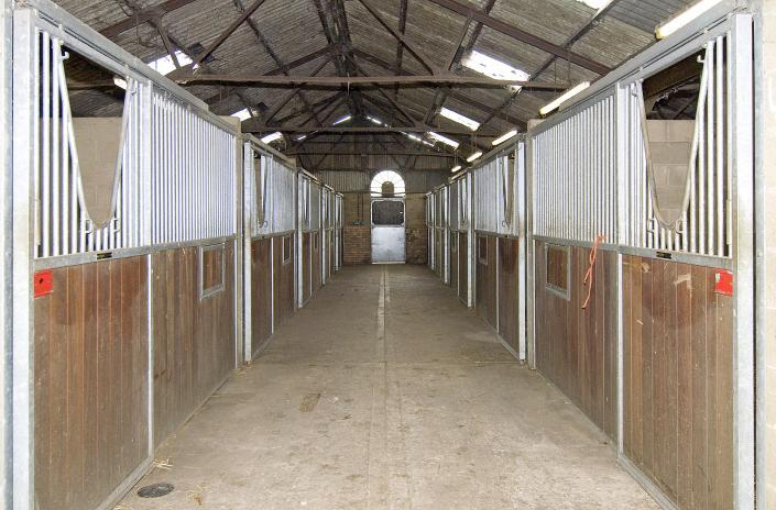 (12) Large forage/storage barn accessible from either end, adjacent are two fuel tanks, large area for muck storage and access for vehicles.