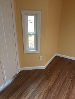 Flooring is laminate wood grain material.