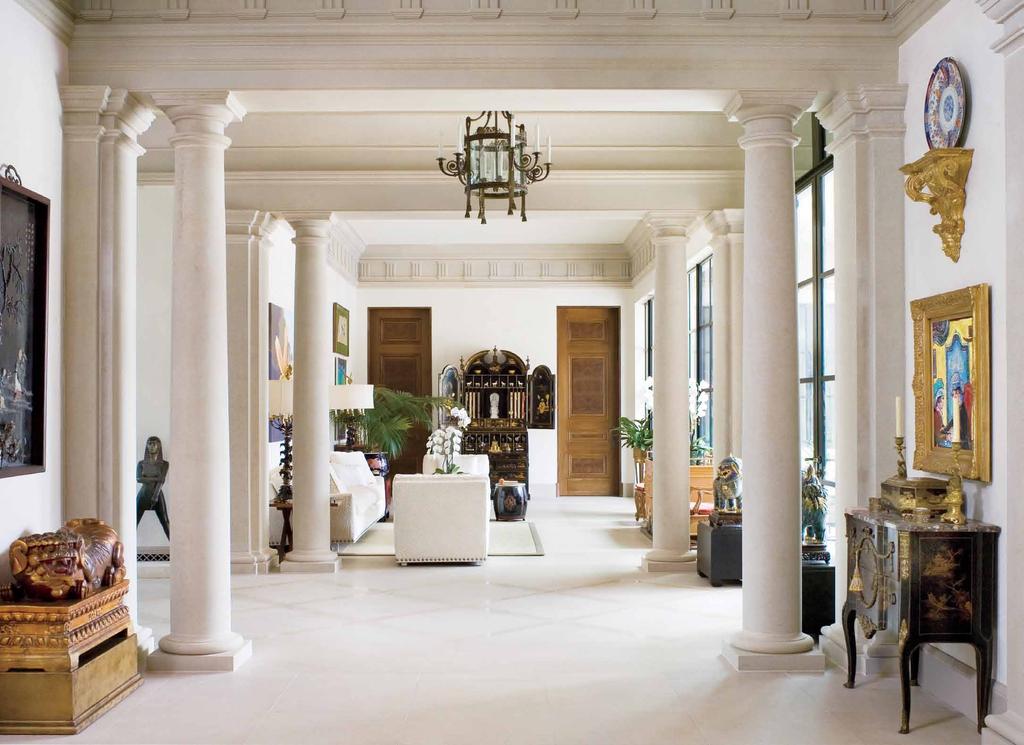Limestone columns and moldings give visual heft to the home s open-plan galleries and public spaces, where much of the wife s art collection is on display.