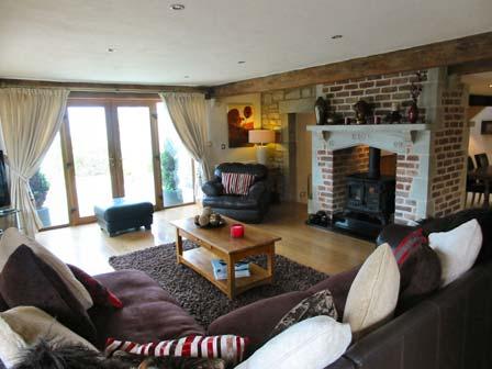 Fully tiled floor, double panelled radiator and exposed beams. Feature fireplace.