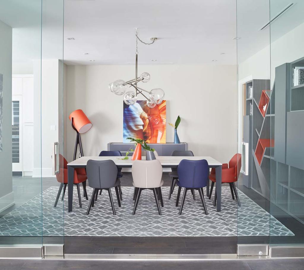 The monochromatic dining room is broken up with vibrant blue and orange accents. STORY CATALINA MARGULIS PHOTOGRAPHY JASON HARTOG YORKVILLE gem A YORKVILLE CONDOMINIUM GETS THE STAR TREATMENT.
