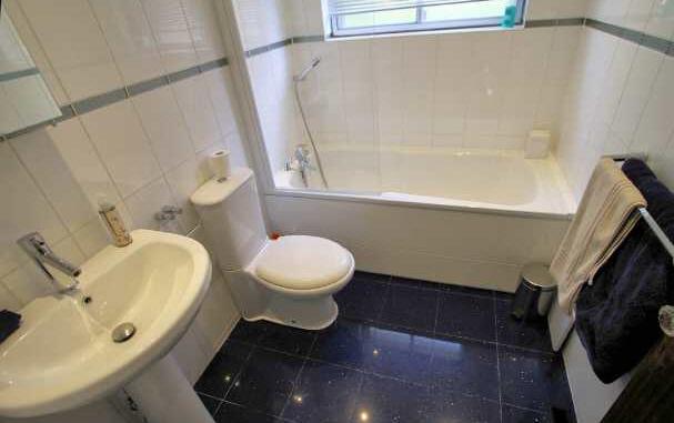 There are ½ tiled walls, ceramic floor tiles, inset ceiling spotlights, opaque window to the rear and extractor fan.