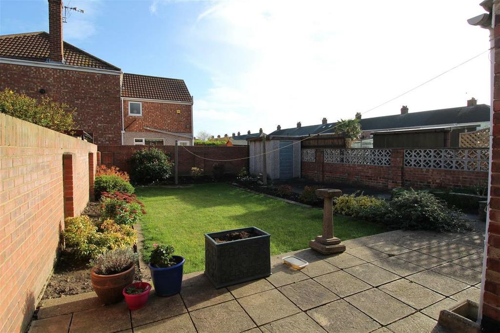 The back garden, all three boundaries are walled, the back garden is mainly put to lawn and patio areas, flower