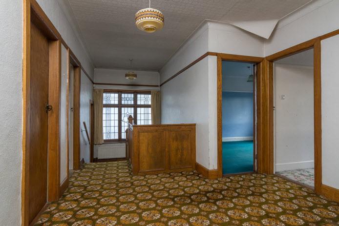 SPACIOUS LANDING: Feature leaded glass window, access to large roofspace