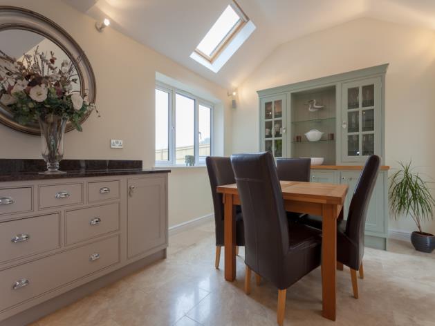 The property has been extended to incorporate a kitchen/dining family room, fitted to a high specification with vaulted ceiling and wood burning