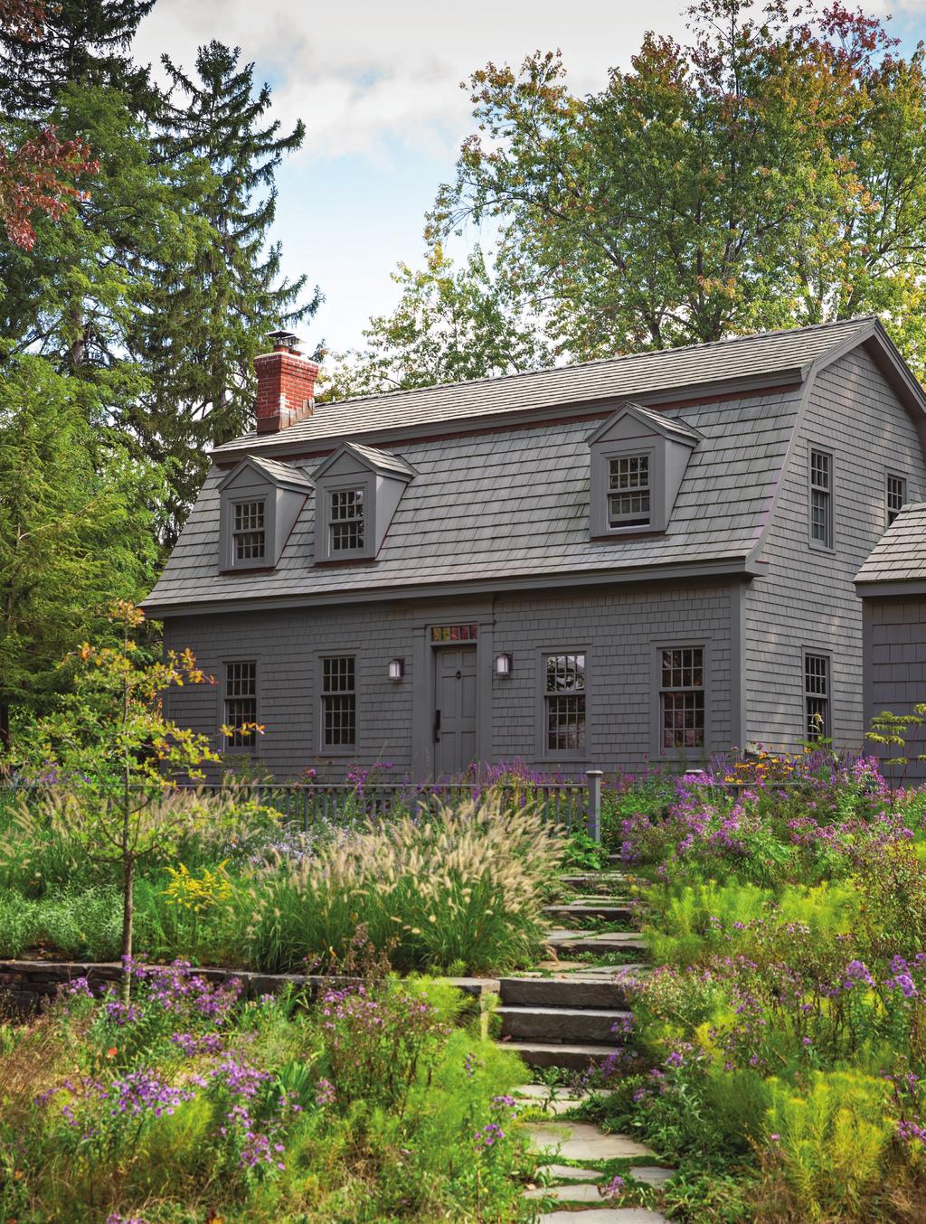 this photo: Restorative, flowing gardens adorn this half-acre property and embrace the historic roots of the home.