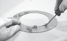 32 - The heat shield is shipped flat and must be hand bent into a half circle before attaching it to the trim ring. Bend the heat shield as shown. CAUTION Risk of Cuts.
