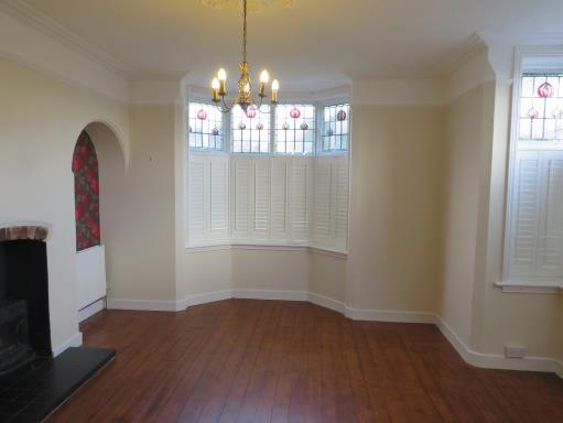 96m into recess excluding bay ) A light and attractive room with two double glazed bay windows to the front and side with colonial style shutters and stained glass panels above, a multi-fuel burning
