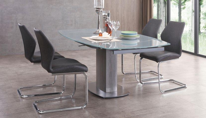 The extending dining table has a glossy grey or taupe tempered glass top