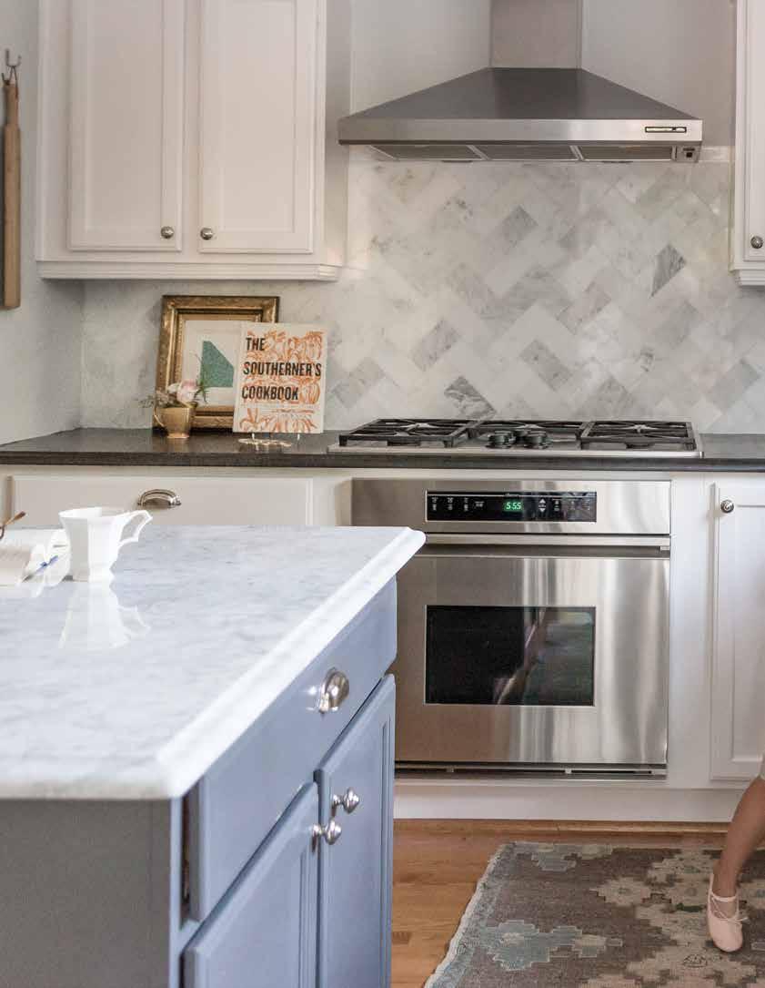 The original kitchen was choppy and cramped, so Kristin Tharpe opened up the layout. She made the island larger and added a Carrara marble top.