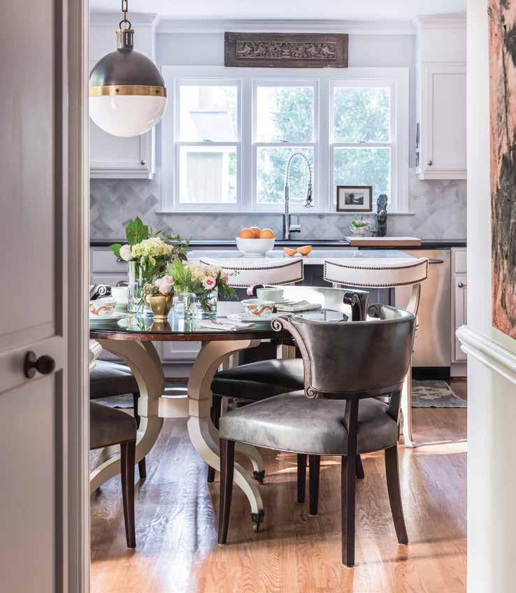 Above: A round dining table in the breakfast nook creates a soft visual with a painted base and wood top and is accented by chairs with dark grain leather.