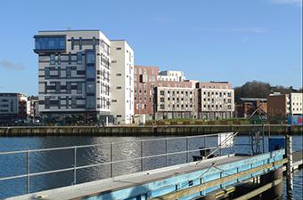 Across the lock gates and over the New Cut Felaw Street Maltings have found a good new use and between these and the west end of the dock stands a large-scale development of new housing, varied in