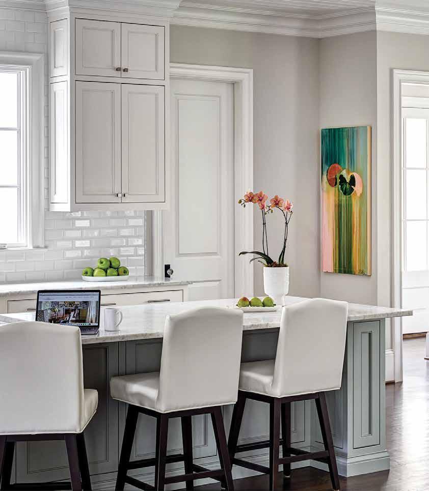 Clean, white, crisp is how the kitchen reads. The counter stools and chairs are by Sunpan.