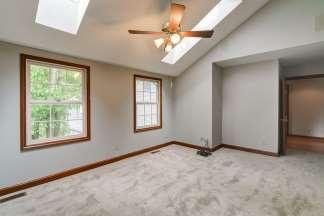 floor (heated in front of vanity), vaulted ceiling, skylight, cherry double vanity
