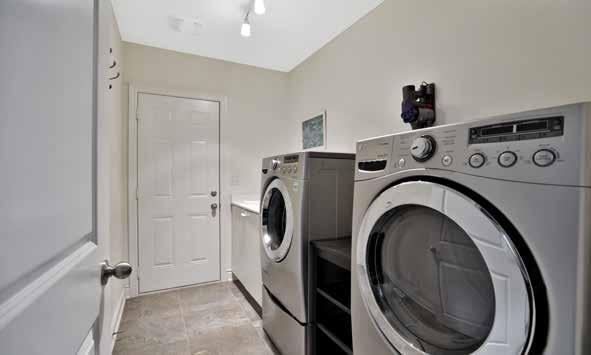Laundry Room Sizable laundry room with upgraded 18 x 18 stone-look polished porcelain floor tiles Large white base cabinet with a deep moulded washtub Halogen lighting Master Bedroom (4.56 x 3.
