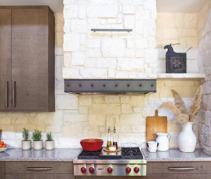 This rustic, contemporary kitchen sits along a massive wall of white Austin limestone. Wood-Mode cabinets by Cabinet and Designs, Inc.