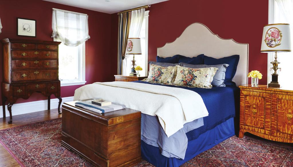 The look in this room is masculine with warm cranberry walls with additional reds, creams, taupes and blues.
