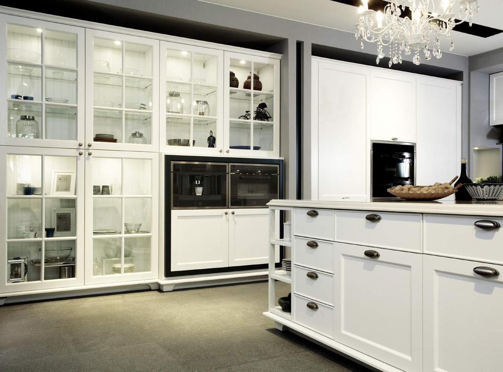 The resplendent looking tall cabinet is fitted with mullion-styled glass door in white matt lacquer finish.