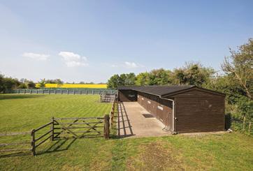 railed paddock, concrete stable yard with a range of 5 wooden stables with power, light and feed store, together with trailer parking Access to a recently constructed all weather manege, post and