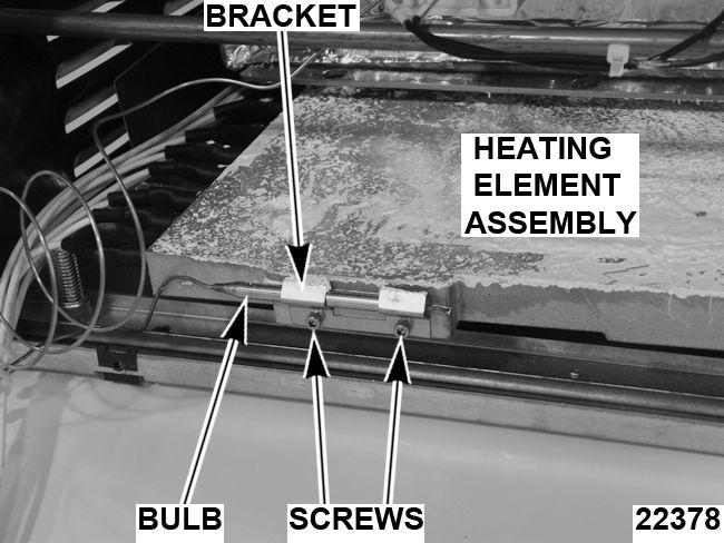 Remove screw and heat shield. Fig. 28 5. Partially remove heater block from heat shield assembly (tray) by pulling assembly towards you. 6. Remove high limit thermostat bulb and bracket. 3.
