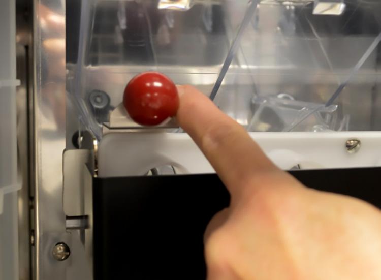 Lock the Bean Hopper into place by pushing the hopper lock mechanism (Red Ball) to the left as shown.