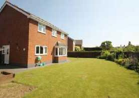 presented detached family home with a generous rear garden backing onto open fields to the rear.