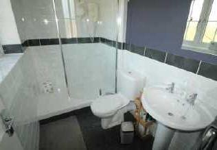 En-Suite Beautifully appointed having a window to the front, walk in double shower cubicle with curved screen and Mira