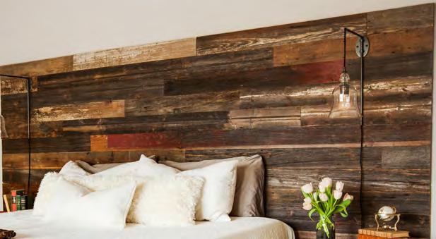 The master bedroom is a calm retreat full of reclaimed barn wood and industrial details.