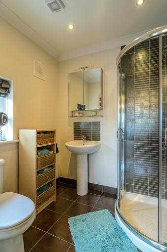 ENSUITE SHOWER ROOM: Tiled shower cubicle with thermostatically controlled shower