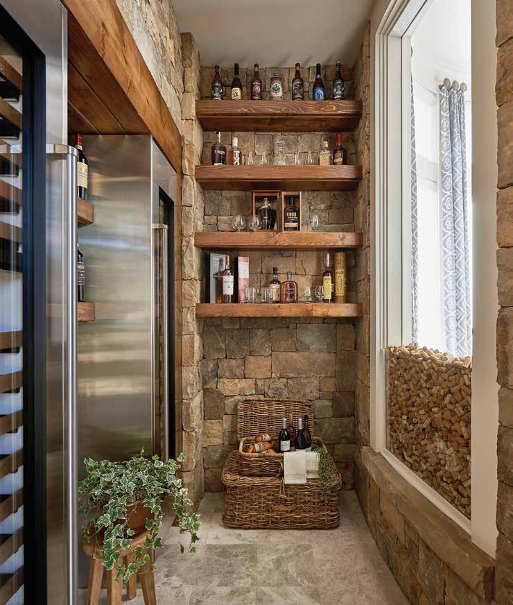 Above: The wine and whiskey room draws guests in with its enticing collections. Wine towers are by Sub-Zero. and friends for great gatherings. The timeline of this project required several years.